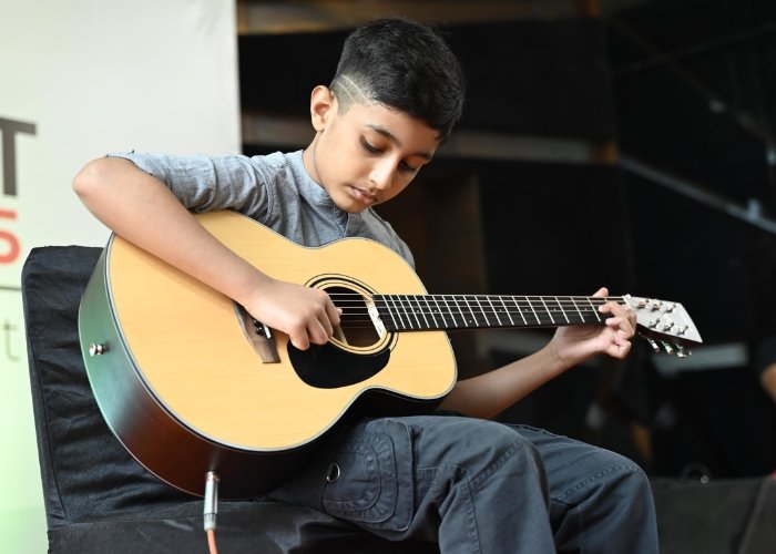 Child learning guitar