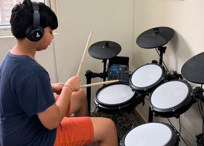 Child learning drums